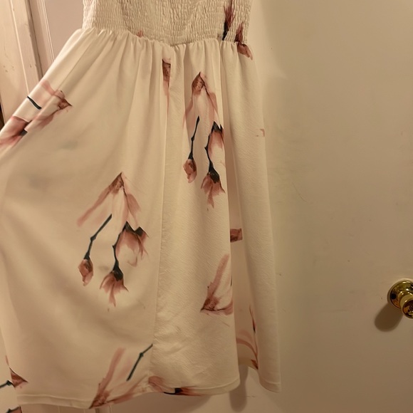 It is white with pink flowers and brown buttons. - Picture 2 of 2